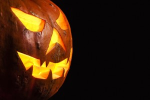 Three quarter view spooky halloween pumpkin Jack O Lantern shiny inside isolated