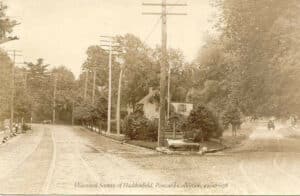 Early 20th century picture postcard / photograph of the junction at Tanner and Haddon, showing the site now occupied by the Haddonfield Public Library, with the original wooden house that stood there.