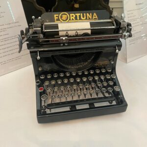 Vintage Fortuna typewriter with black case/ body and round keys.